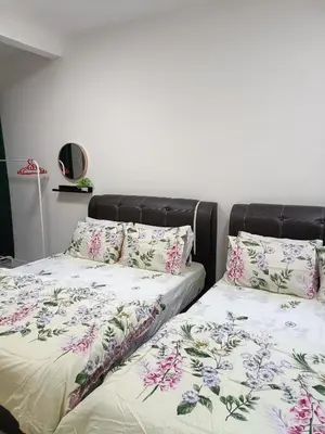 two beds sitting next to each other in a bedroom at Alyaleesya Emerald avenue 4 Brinchang for muslim in Brinchang
