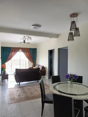 a living room with a table and a couch at Alyaleesya Emerald avenue 4 Brinchang for muslim in Brinchang