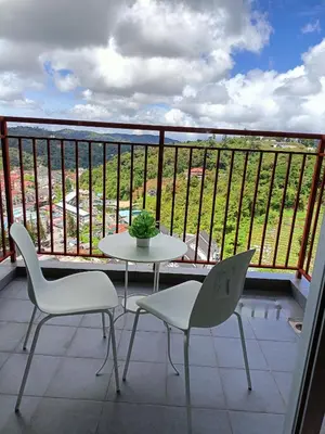 a table and two chairs on a balcony with a view at Alyaleesya Emerald avenue 4 Brinchang for muslim in Brinchang