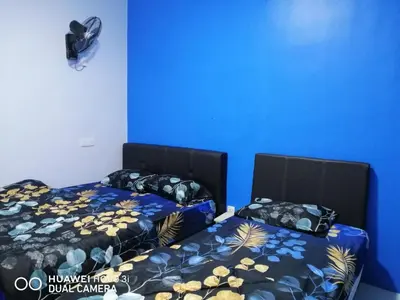 two beds sitting next to each other in a room at Alyaleesya homestay Emerald Avenue 1 Brinchang in Brinchang