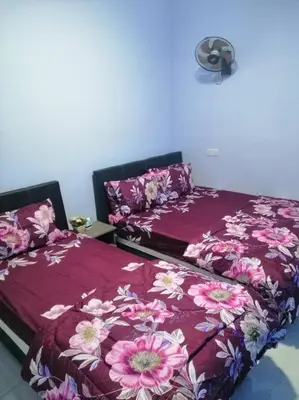 two beds sitting next to each other in a bedroom at Alyaleesya homestay Emerald Avenue 1 Brinchang in Brinchang