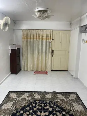 a living room with a door and a rug on the floor at Family House in Jelutong