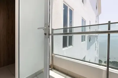an open glass door to a balcony in a building at Mansion One Executive Studio 2pax in George Town