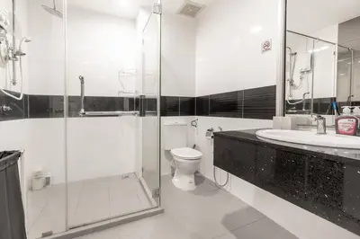 a bathroom with a shower and a toilet and a sink at Mansion One Executive Studio 2pax in George Town