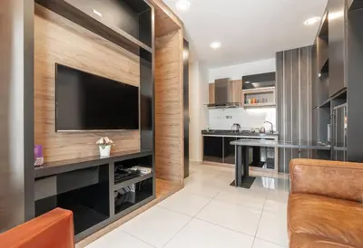 a living room with a television and a kitchen at Mansion One Executive Studio 2pax in George Town