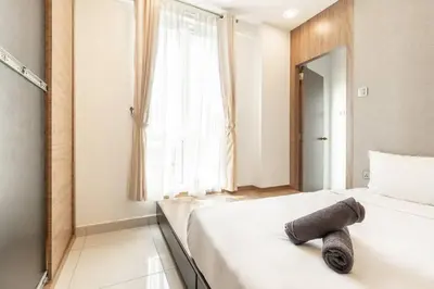 a bedroom with a white bed and a window at Mansion One Executive Studio 2pax in George Town
