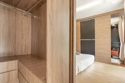 a bedroom with a bed and a walk in closet at Mansion One Executive Studio 2pax in George Town
