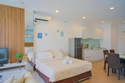 a bedroom with a large bed and a kitchen at Mansion One l 4pax Studio l Cityview l Gleneagle l by PerfectSweetHome in George Town