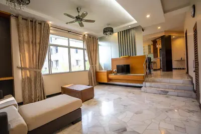 a living room with a couch and a television at Cozy Gurney Georgetown Private Apartment Penang in George Town