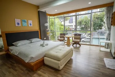 a bedroom with a large bed and a large window at Cozy Gurney Georgetown Private Apartment Penang in George Town