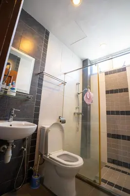 a bathroom with a toilet and a sink and a shower at Cozy Gurney Georgetown Private Apartment Penang in George Town