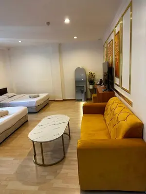 a living room with a couch and a table at GOA INN HOTEL SDN BHD in Gua Musang