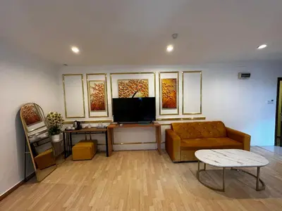 a living room with a couch and a tv at GOA INN HOTEL SDN BHD in Gua Musang