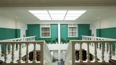 a staircase in a building with green walls and a skylight at Kimberley Boutique Hotel in George Town