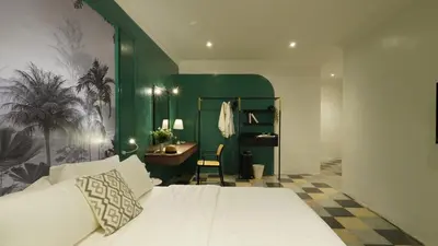 a bedroom with a bed and a desk in it at Kimberley Boutique Hotel in George Town