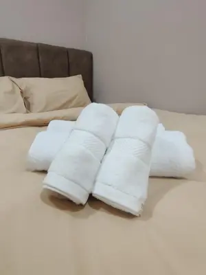 a pile of white towels sitting on a bed at IPOH Waterpark Homestay By SummerStay 5km to IPOH TOWN in Ipoh