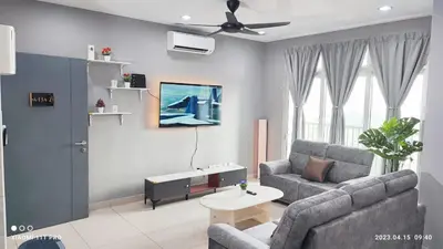 a living room with a couch and a table at kakao homestay ipoh town 2parking 3room 10pax wifi in Ipoh