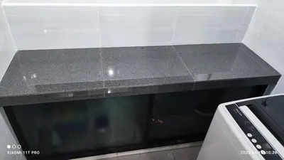 a black counter top in a kitchen next to a stove at kakao homestay ipoh town 2parking 3room 10pax wifi in Ipoh