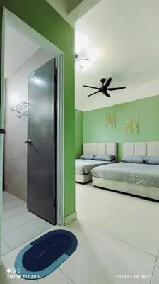 a room with two beds and a ceiling fan at kakao homestay ipoh town 2parking 3room 10pax wifi in Ipoh