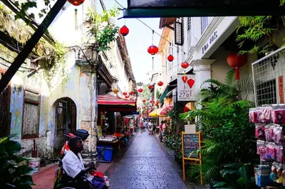 a man riding a scooter down a street in an alley at kakao homestay ipoh town 2parking 3room 10pax wifi in Ipoh