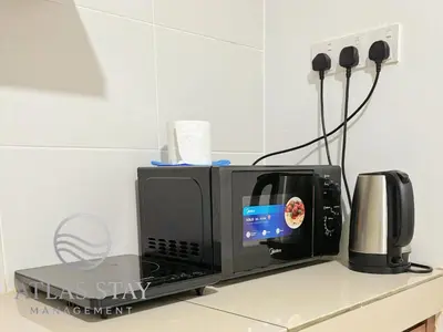 a microwave sitting on top of a counter at IPOH Waterpark Homestay By SummerStay in Ipoh