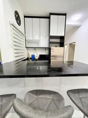 a kitchen with a counter and a chair in it at Lily King (modern and comfy) in Tanah Rata