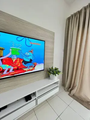 a flat screen tv sitting on top of a cabinet at Lily King (modern and comfy) in Tanah Rata