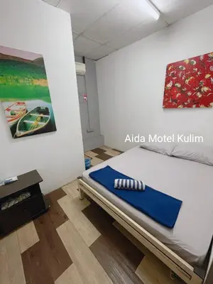 a room with a bed with a painting on the wall at Art Motel Kulim in Kulim