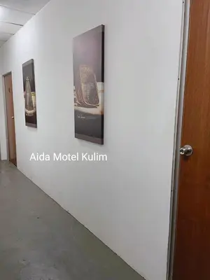 a wall with some pictures on a wall at Art Motel Kulim in Kulim