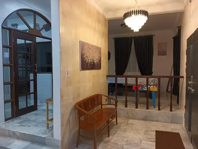 a living room with a couch and a chandelier at Cs Villa Homestay in Ipoh