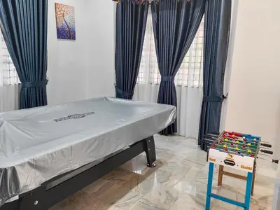a hospital bed in a room with blue curtains at Cs Villa Homestay in Ipoh