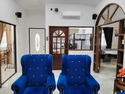 a pair of blue chairs in a living room at Cs Villa Homestay in Ipoh