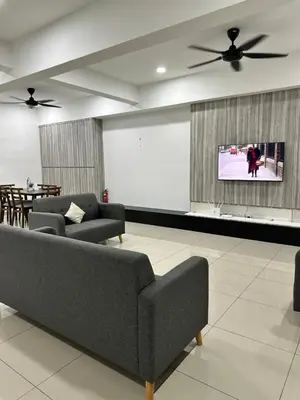 a living room with two couches and a flat screen tv at Manjung Vermogen Stay-Wi-Fi+KTV(Near Aeon) in Sitiawan