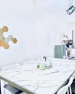 a white table with two mugs on top of it at Homestay Akasia 12 in Seri Iskandar