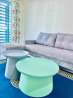 a living room with two tables and a couch at Homestay Akasia 12 in Seri Iskandar