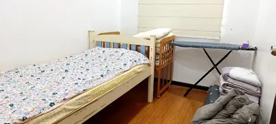 a small bedroom with a crib and a table at Single Storey Bungalow 12 pax in Ipoh