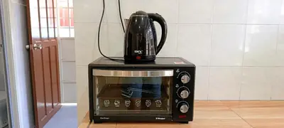 a coffee maker sitting on top of a microwave at Single Storey Bungalow 12 pax in Ipoh