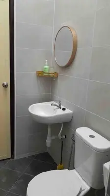 a bathroom with a toilet and a sink and a mirror at Simple Home Taiping \u7b80\u5c45 @ Suria Aman in Kamunting