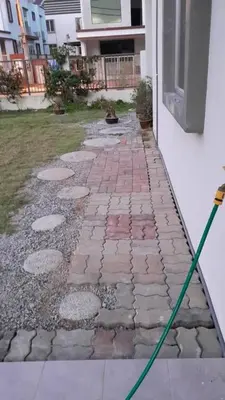 a green hose is attached to a brick walkway at Simple Home Taiping \u7b80\u5c45 @ Suria Aman in Kamunting