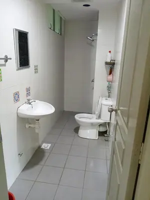 a white bathroom with a toilet and a sink at Family Stay at Quintet A2-7-3A in Tanah Rata