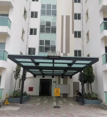 a person sitting under awning in front of a building at Family Stay at Quintet A2-7-3A in Tanah Rata