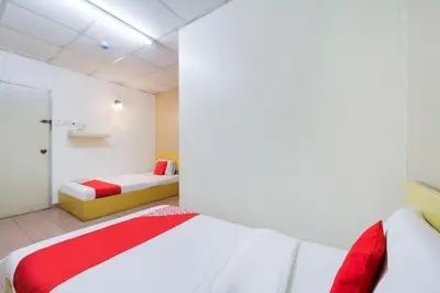 a bedroom with two beds in a room at CP Hotel in Butterworth