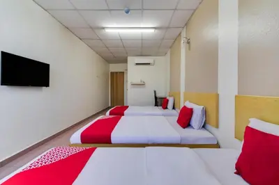 a room with two beds and a flat screen tv at CP Hotel in Butterworth