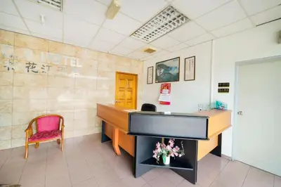 a office with a piano in a room with a chair at CP Hotel in Butterworth