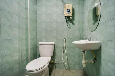 a bathroom with a toilet and a sink at Hotel River Inn in Butterworth