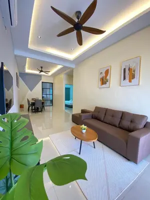 a living room with a couch and a ceiling fan at LYL HOMESTAY-IPOH 10Pax 4R in Ipoh