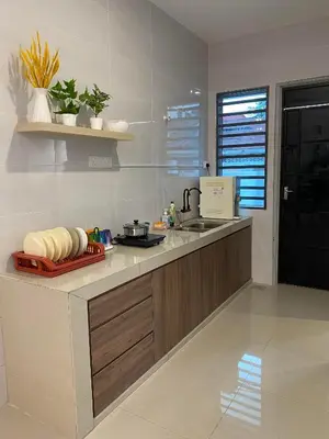 a kitchen with a counter top with a sink and a counter sidx sidx sidx at LYL HOMESTAY-IPOH 10Pax 4R in Ipoh