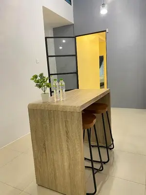 a wooden bar in a room with stools at LYL HOMESTAY-IPOH 10Pax 4R in Ipoh