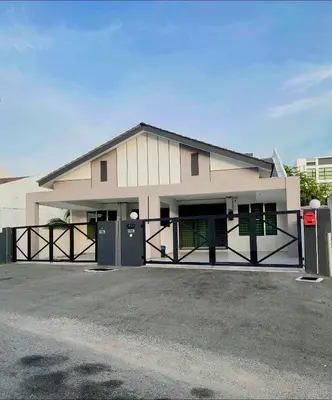 a large white building with a gate and a parking lot at LYL HOMESTAY-IPOH 10Pax 4R in Ipoh