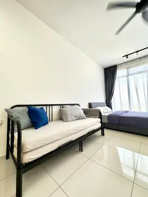 a living room with two beds and a ceiling fan at Beacon Executive Suites #Georgetown #InfinityPool #15 in George Town